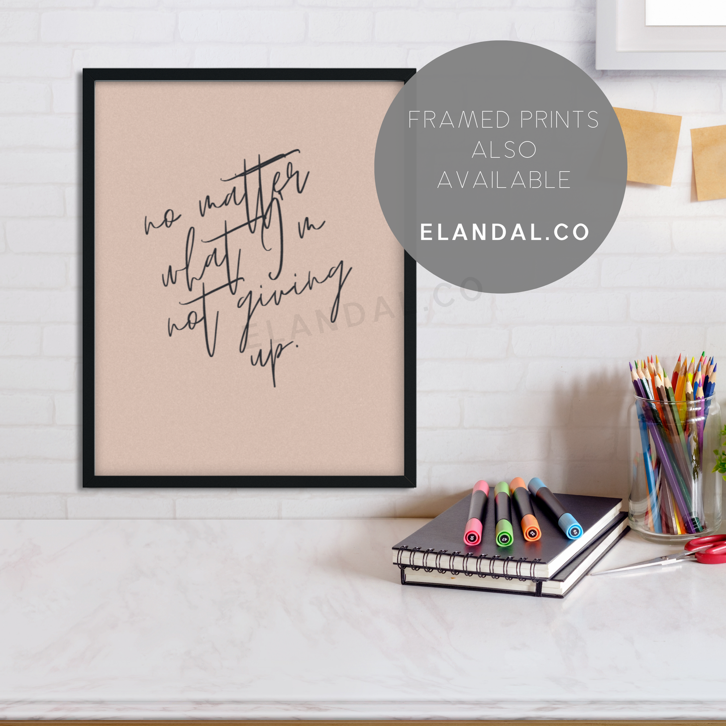 Image of black framed edition of the "No Matter What, I'm Not Giving Up" wall art from El and Al Co hanging up on an office wall.