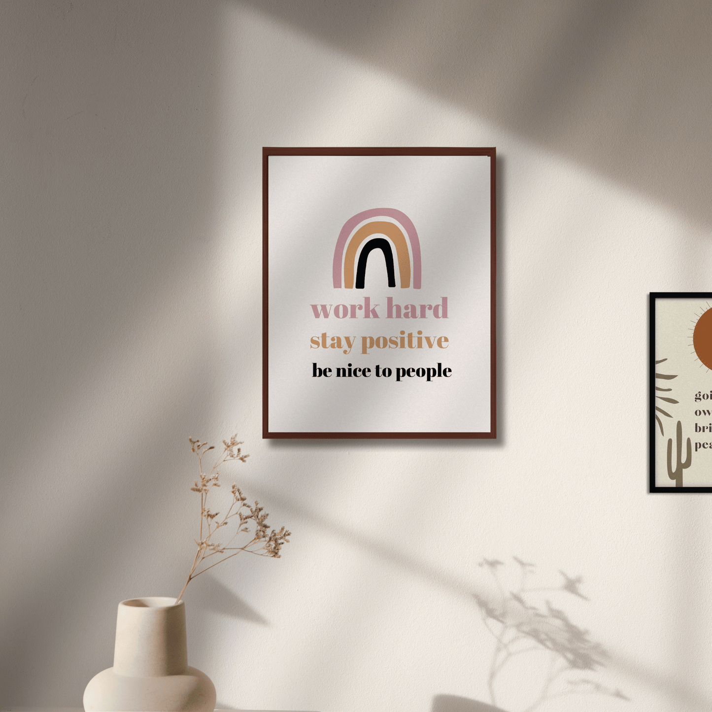 Framed motivational poster with rainbow design on a wall with soft lighting