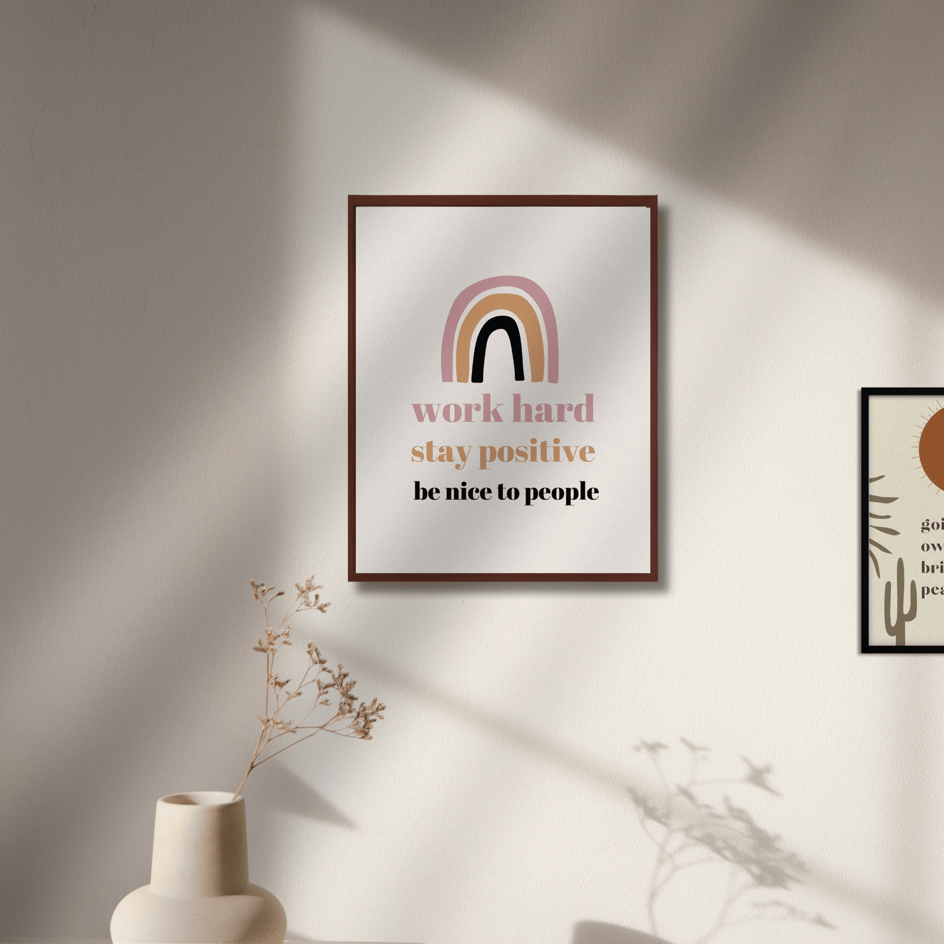 Framed motivational poster with rainbow design on a wall with soft lighting